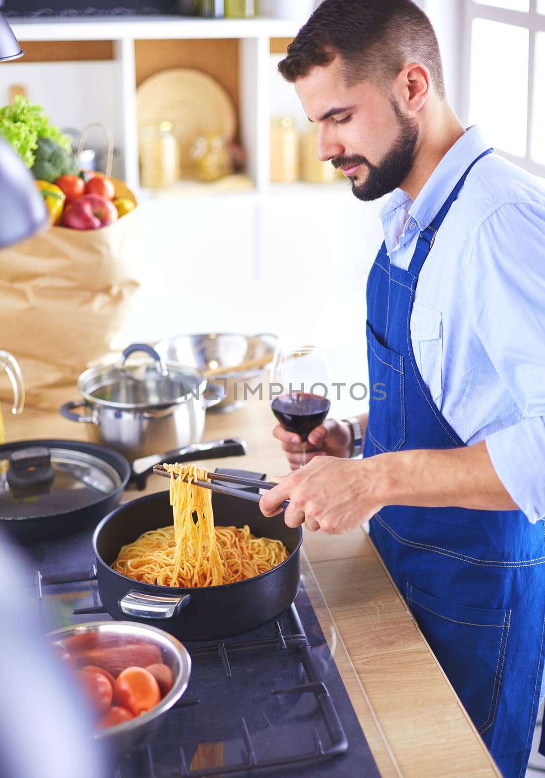 Man preparing delicious and healthy food in the home kitchen by lenets