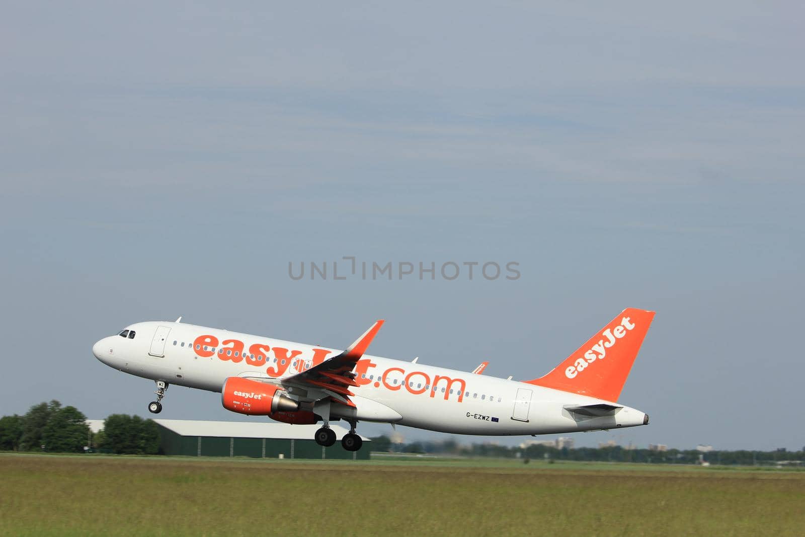 Amsterdam, the Netherlands  -  June 2nd, 2017:G-EZWZ easyJet Airbus A320-200 taking off from Polderbaan Runway Amsterdam Airport Schiphol