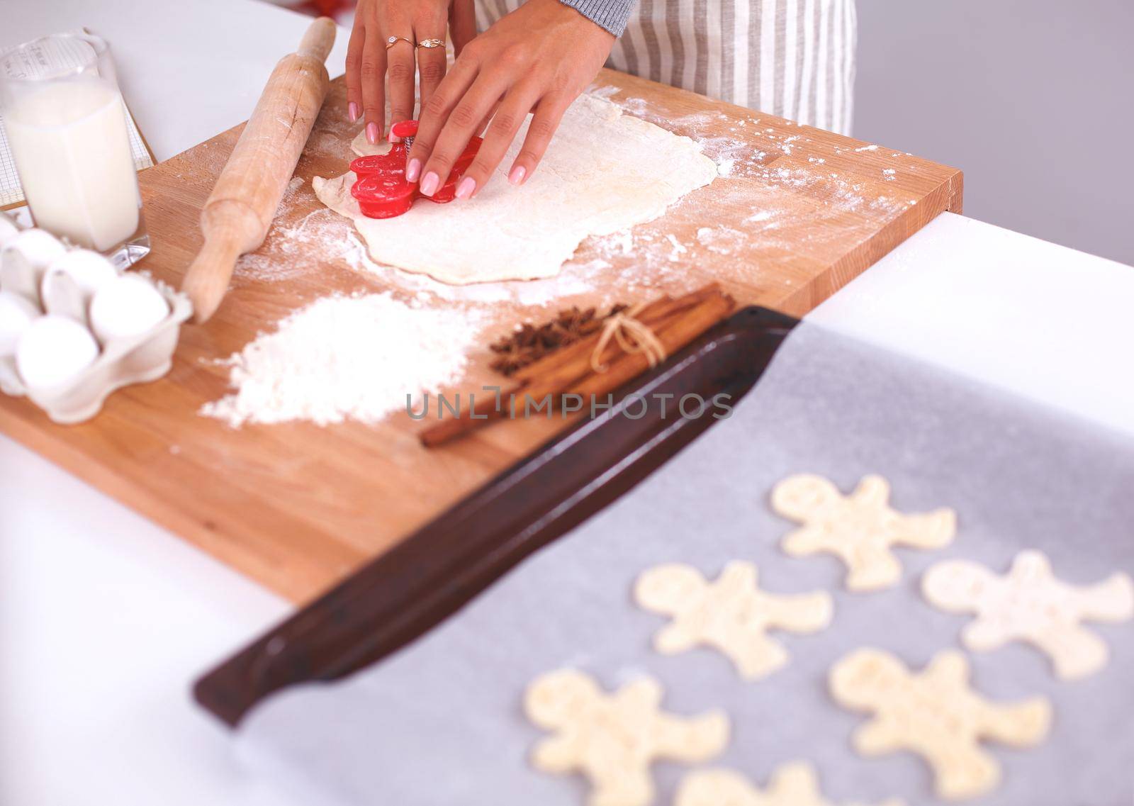 Woman making christmas cookiesin the kitchen, isolated