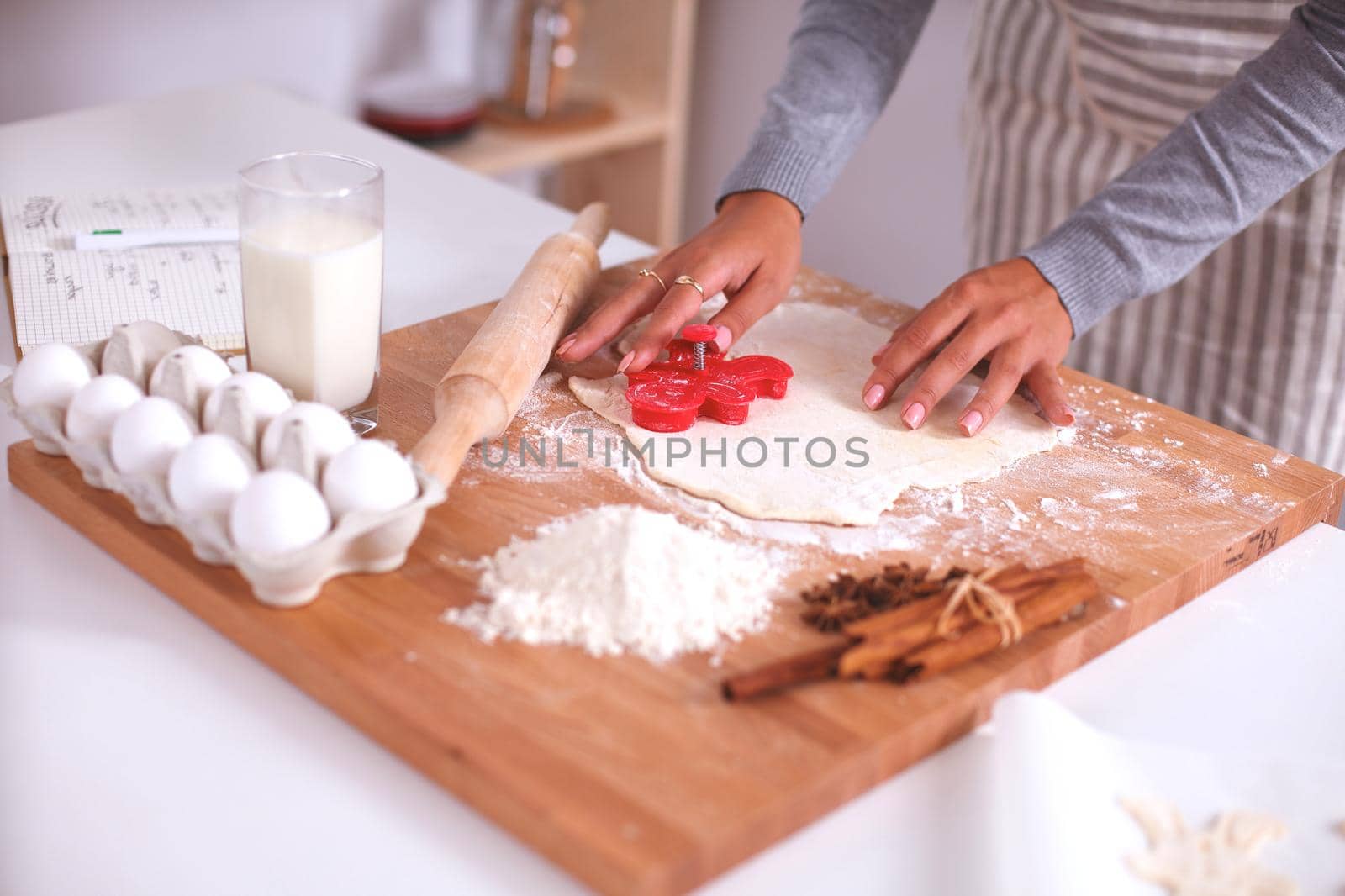 Christmas baking santa woman smiling happy having fun with Christmas preparations wearing Santa hat