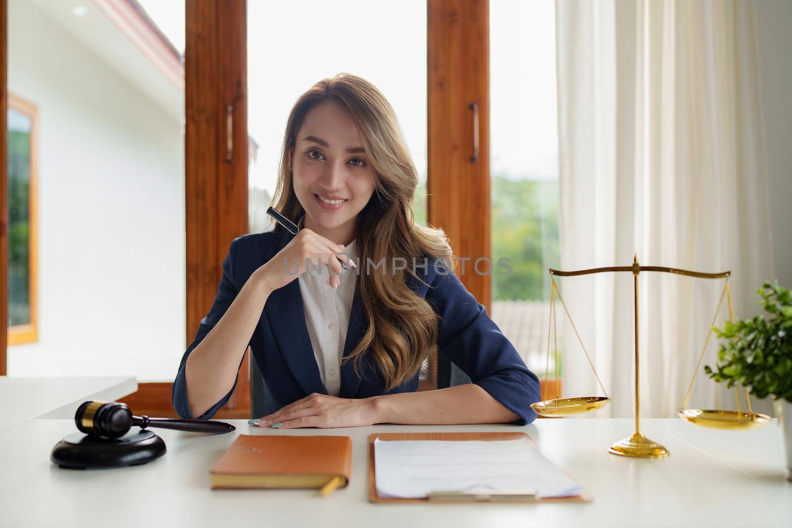 Lawyer business woman working or reading agreement contract in office workplace for consultant lawyer concept. by itchaznong