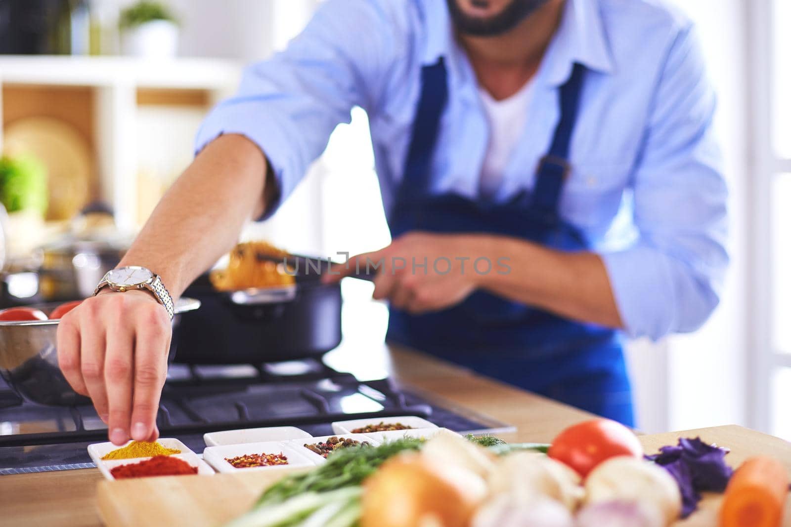 Man preparing delicious and healthy food in the home kitchen.