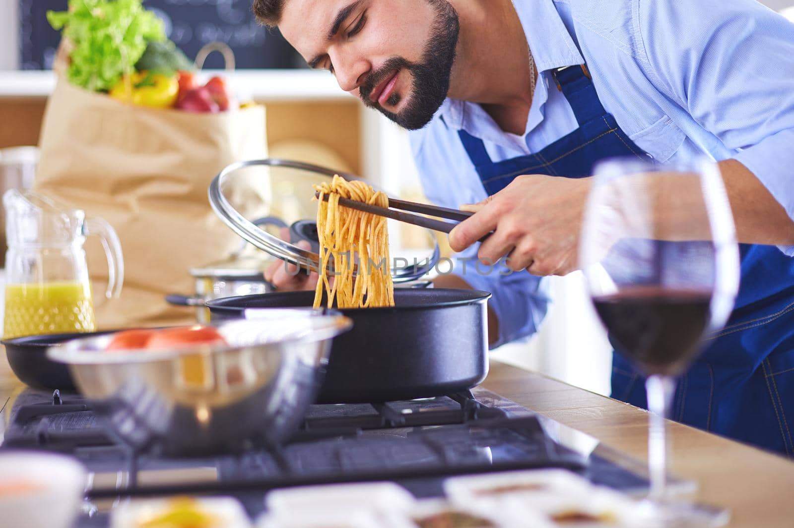 Man preparing delicious and healthy food in the home kitchen.