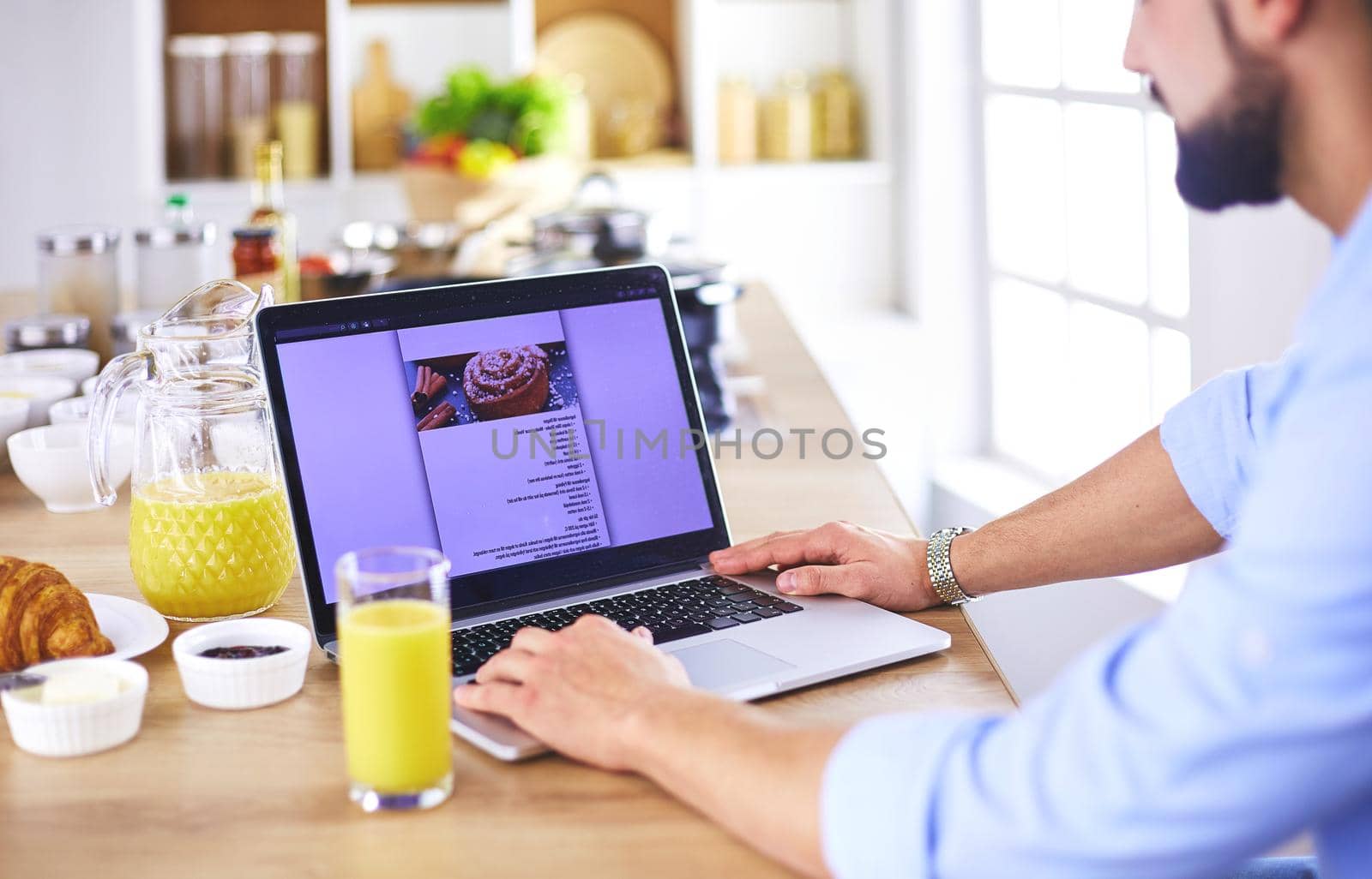 Man preparing delicious and healthy food in the home kitchen by lenets