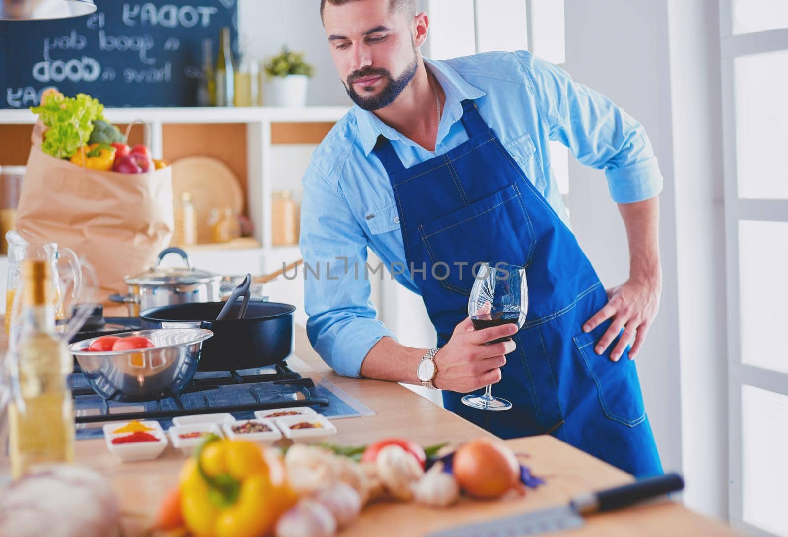 Man preparing delicious and healthy food in the home kitchen by lenets