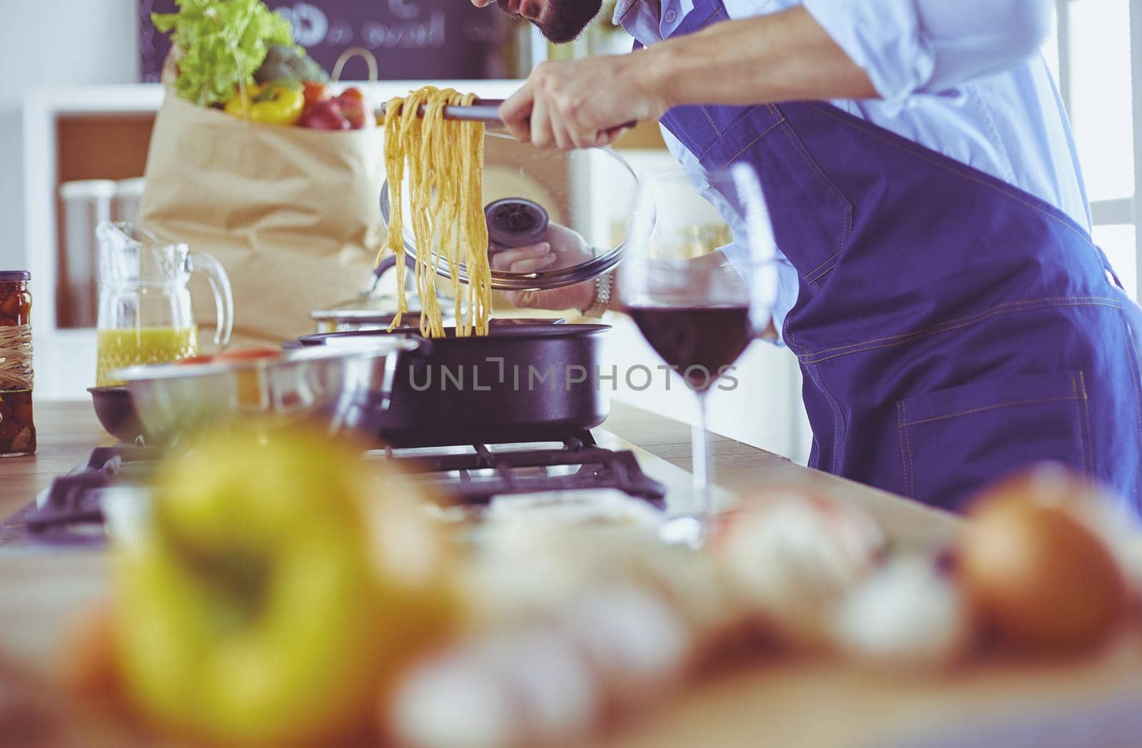 Man preparing delicious and healthy food in the home kitchen by lenets