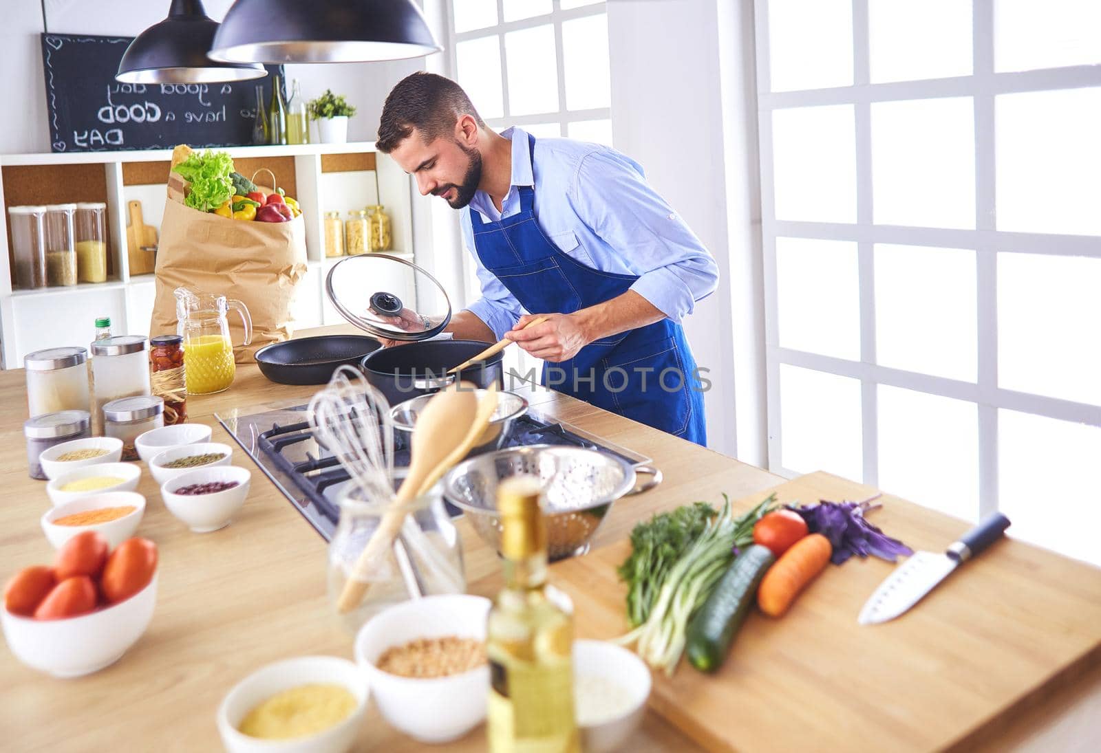 Man preparing delicious and healthy food in the home kitchen.