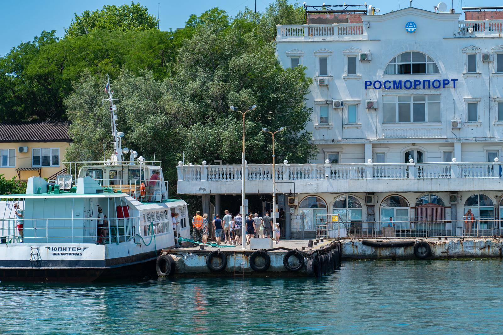 RUSSIA, CRIMEA - JUL 08, 2022: Sevastopol ship port russia water crimea vessel sea harbor warship, from naval city in blue for harbour ea, seaport lagoon. Defense weapon trade,