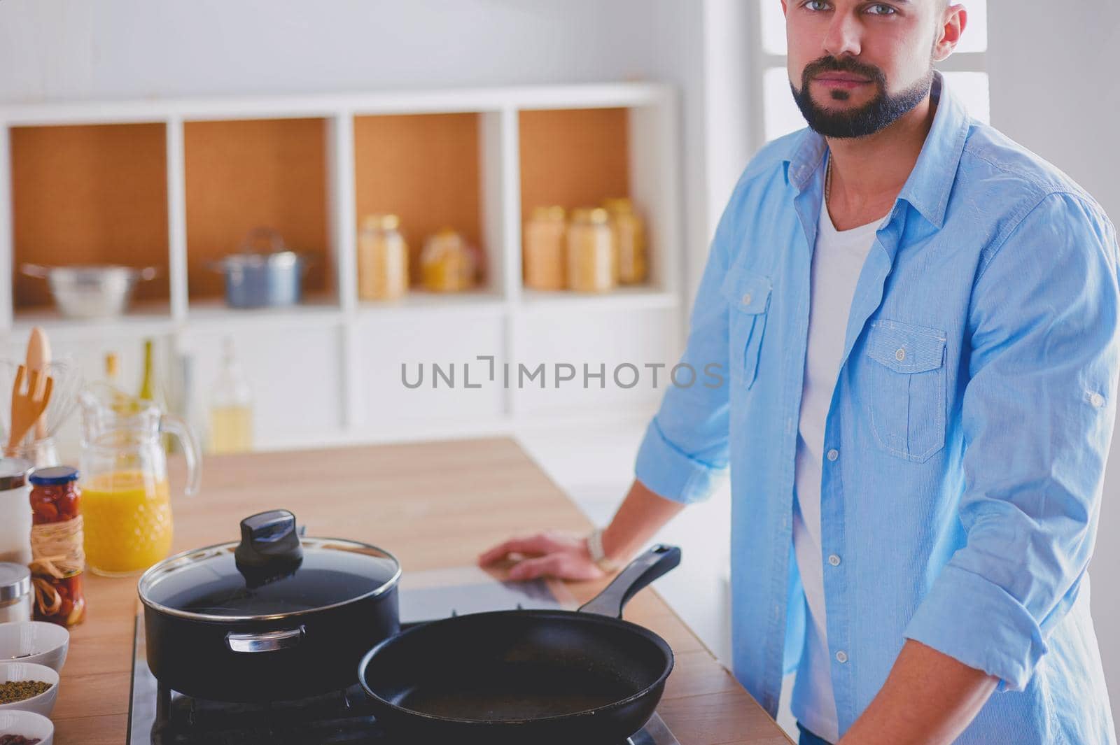 Man preparing delicious and healthy food in the home kitchen by lenets