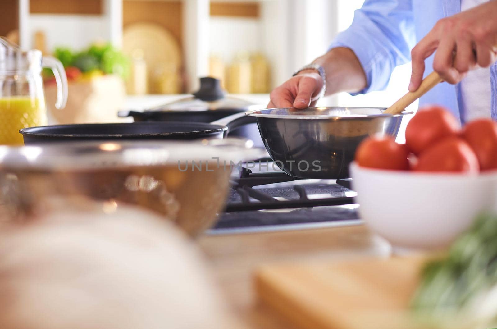 Man preparing delicious and healthy food in the home kitchen.