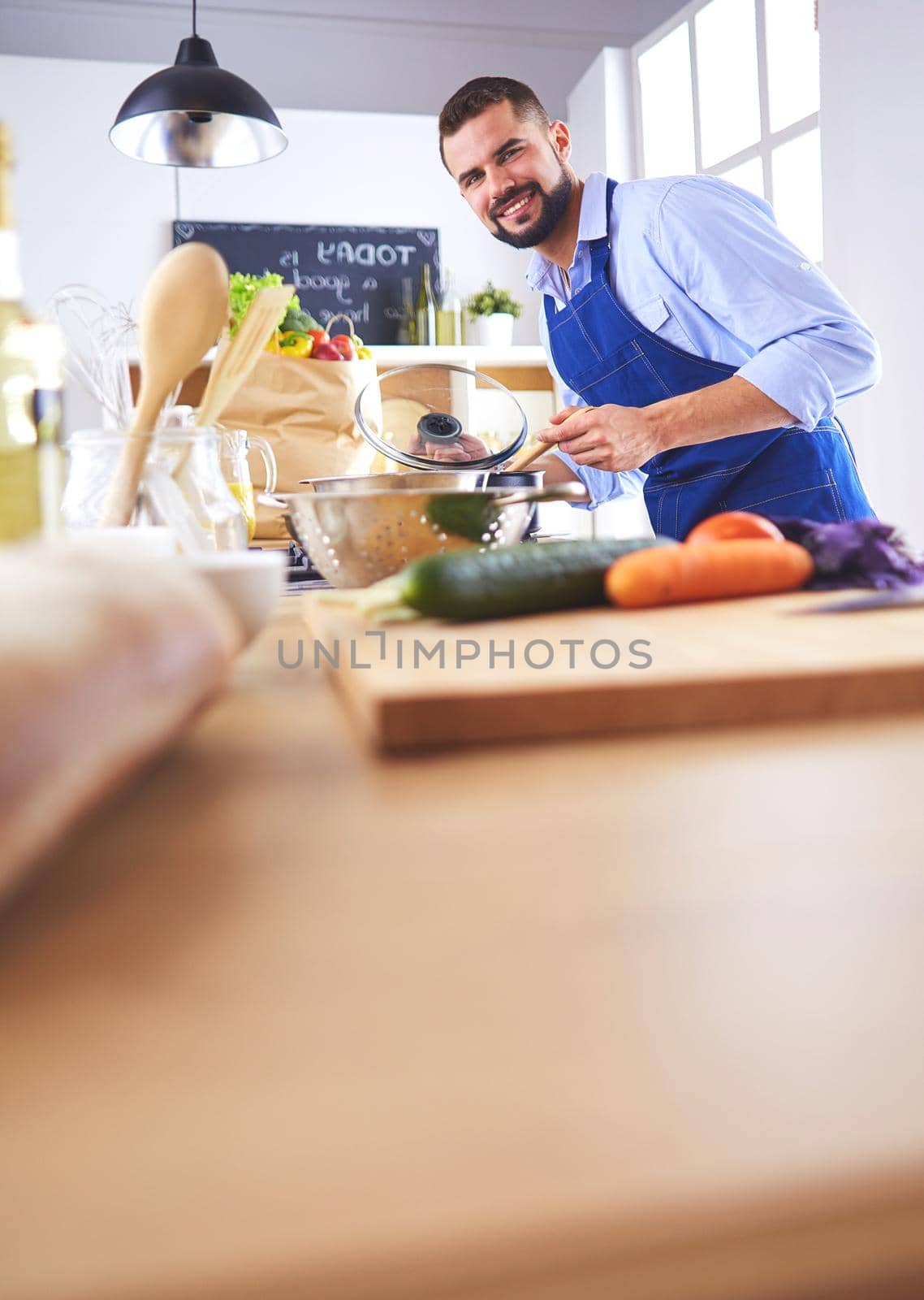 Man preparing delicious and healthy food in the home kitchen by lenets