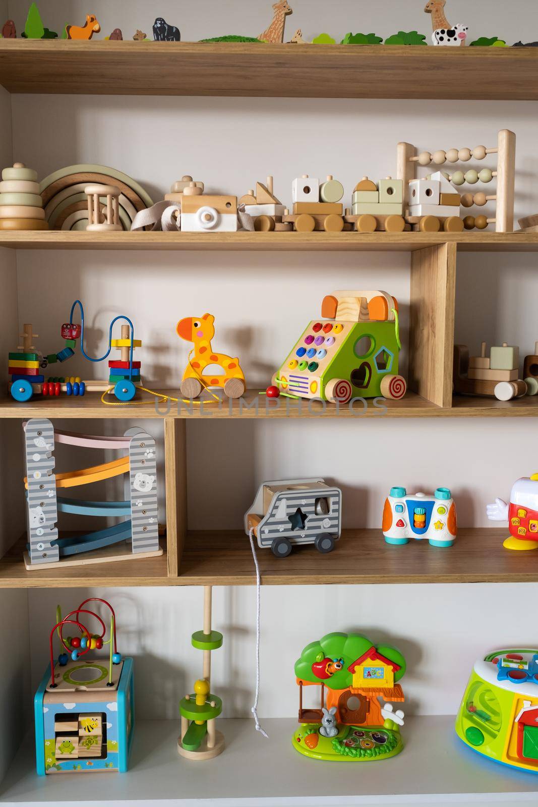 A shelf with children's wooden toys in the children's room. Children's concept.