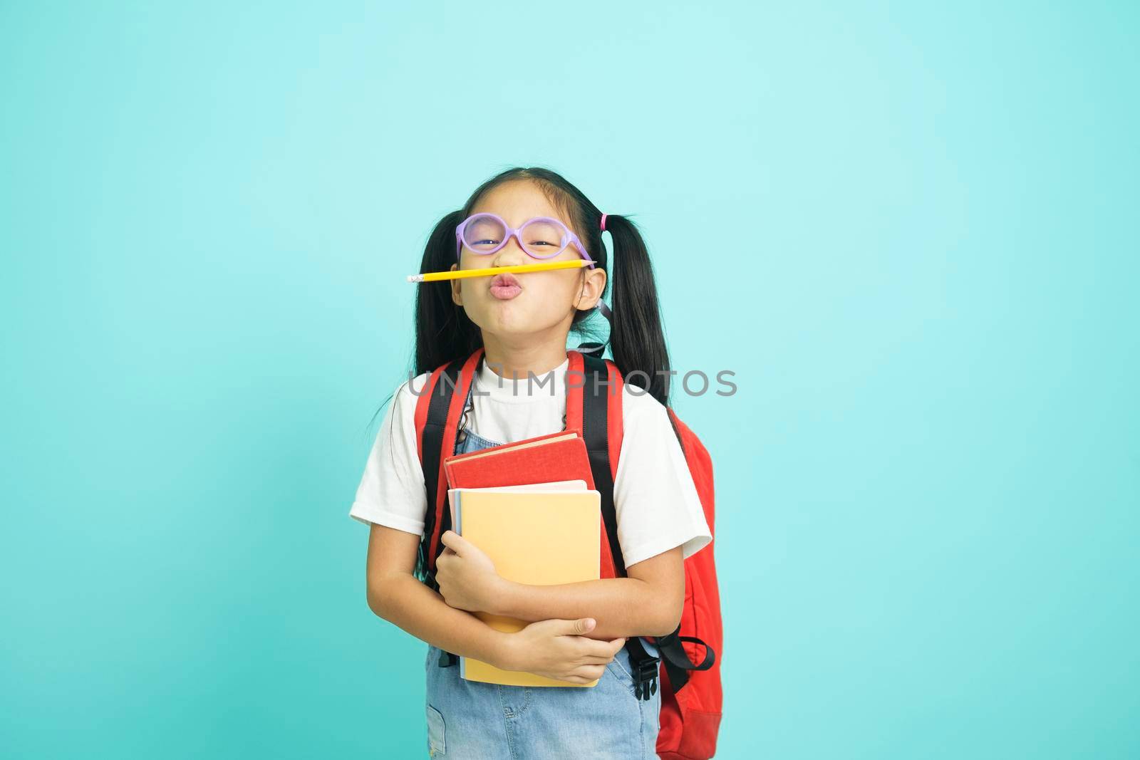 Close-up kid students girl smiling holding book, going to school. by ijeab