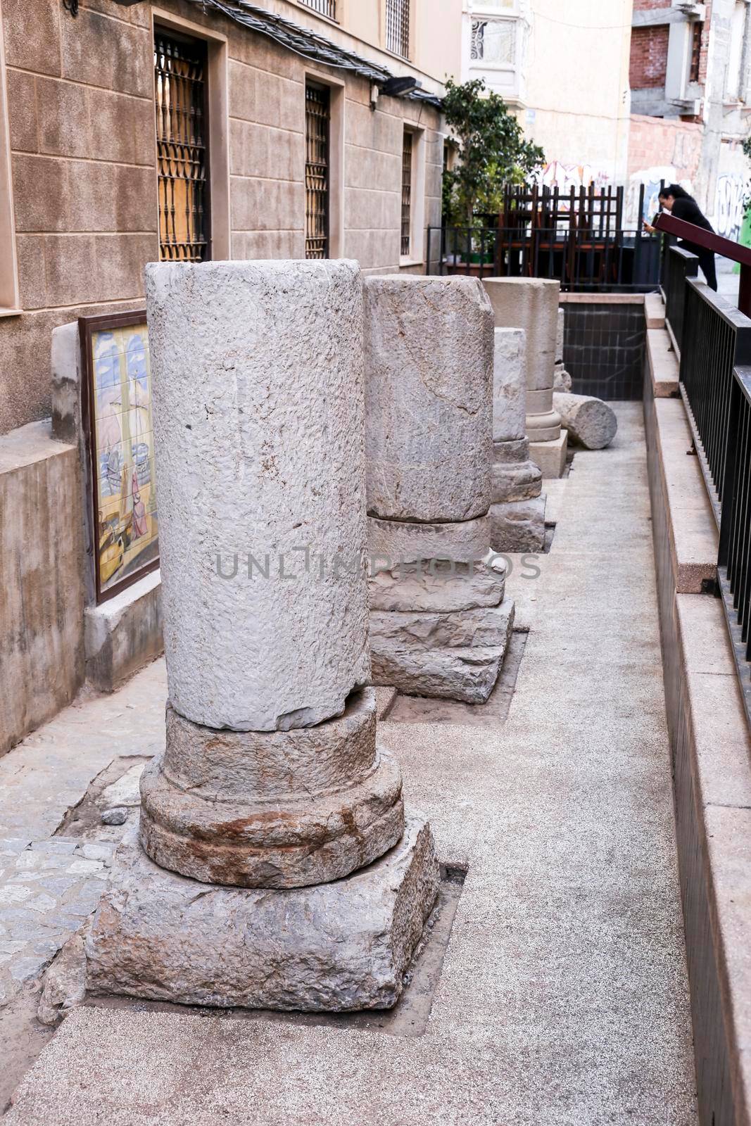 Cartagena, Murcia, Spain- July 25, 2019: Remains of pillars of roman road and temple on the street in Cartagena