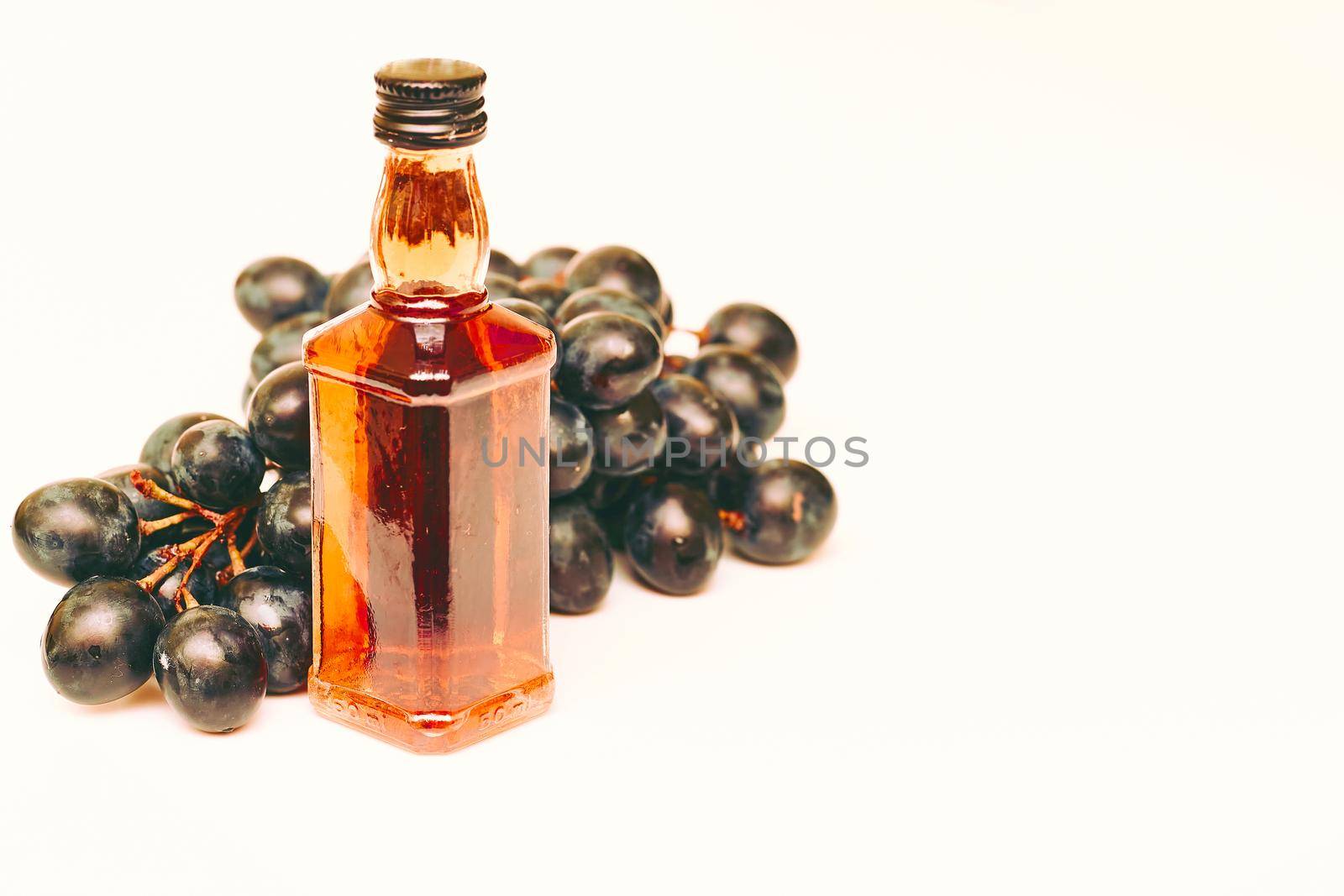 Good old brandy, cognac and black ripe grapes by jovani68