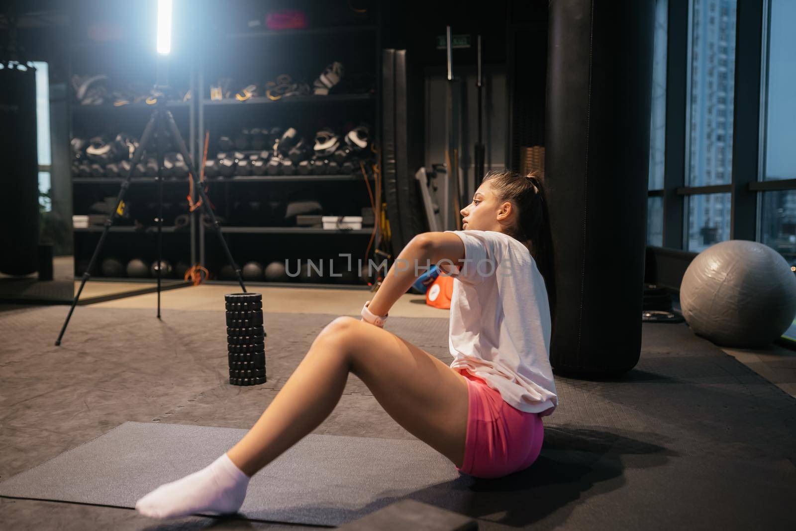 Young woman working out, doing yoga or pilates exercise at the gym
