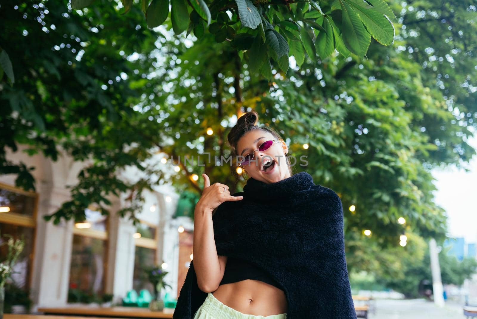 Glamorous white girl fooling around in outdoor cafe. Gorgeous brunette female model in summer day.
