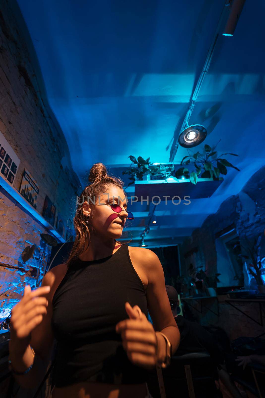 Beautiful female DJ dancing to techno