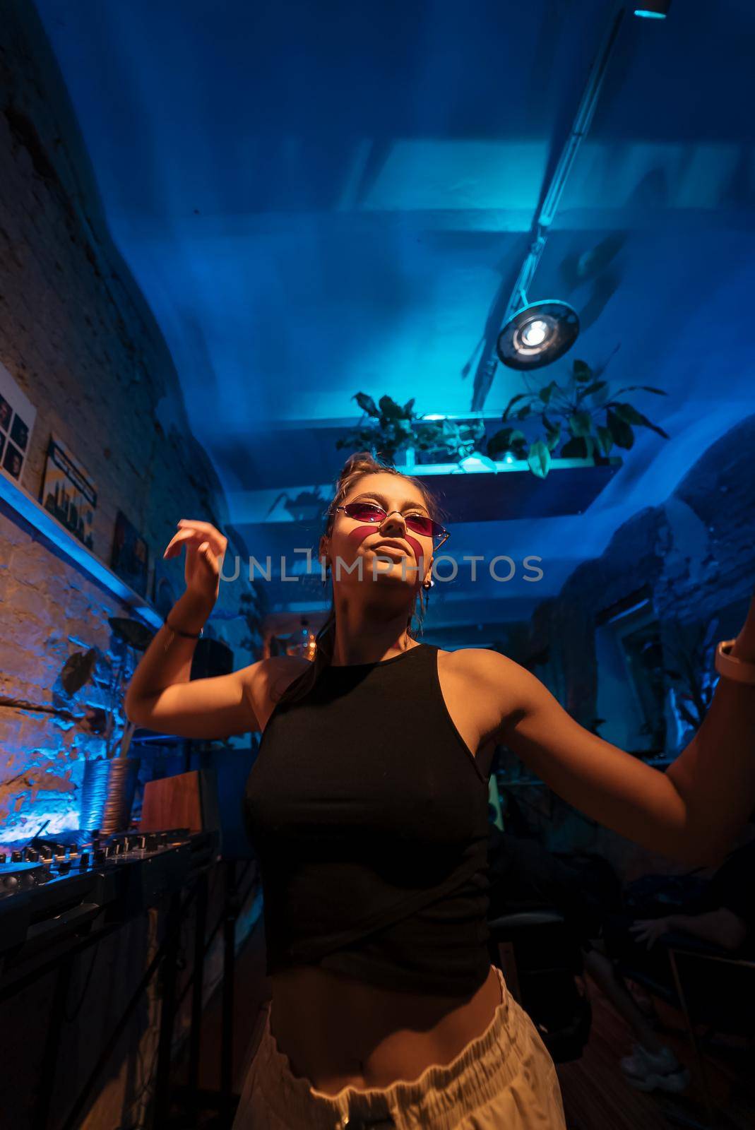 Beautiful female DJ dancing to techno