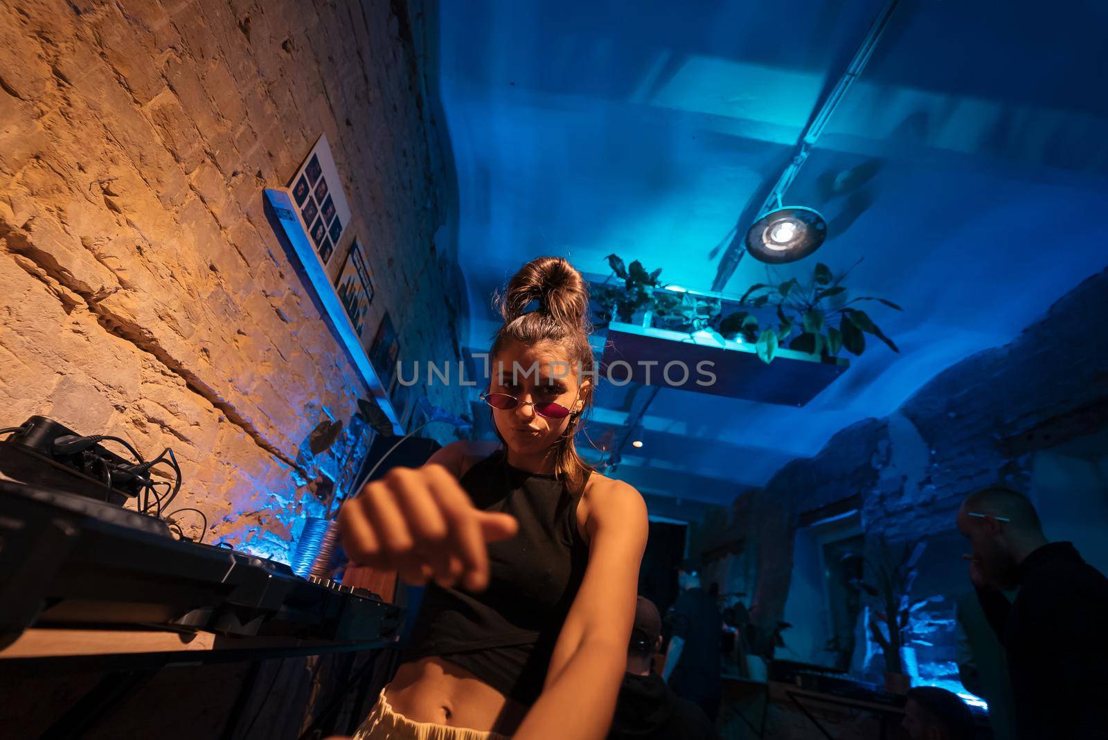 Beautiful female DJ dancing to techno