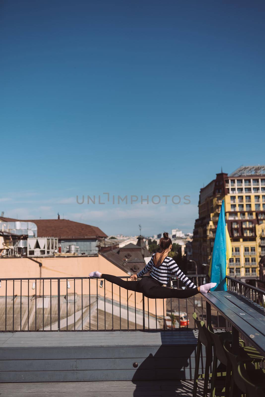 Woman is doing twine on the roof of the house