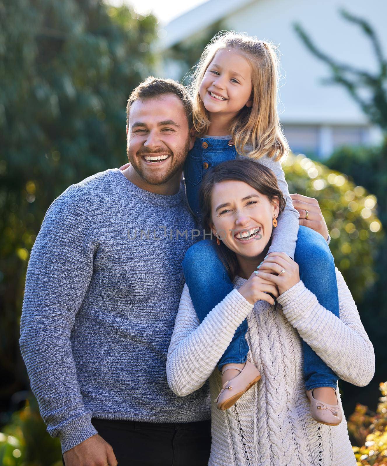 Strong family bonds are essential for a childs development. Portrait of a happy family bonding together outdoors