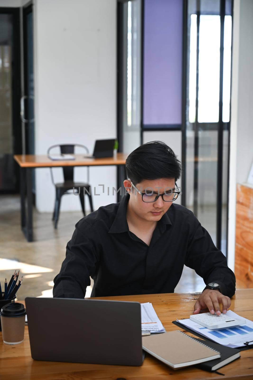 Thoughtful businessman working with computer laptop in office. by prathanchorruangsak