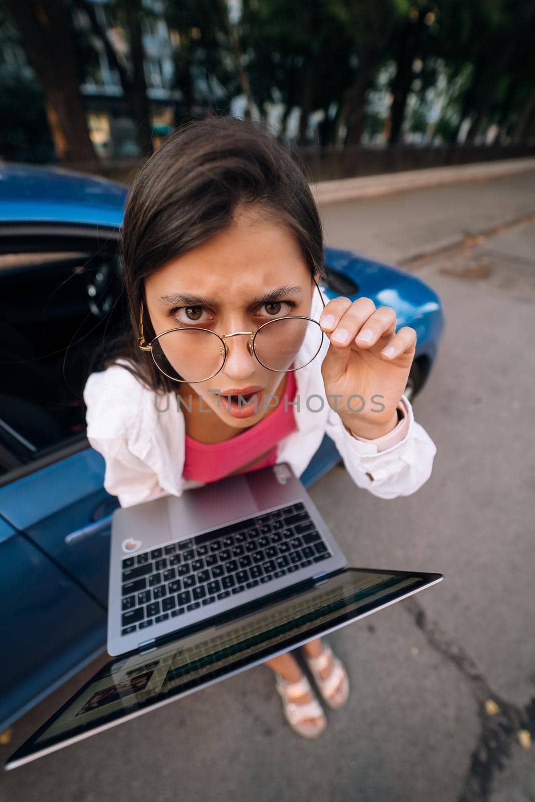 Shocked young brunette hold in hands laptop