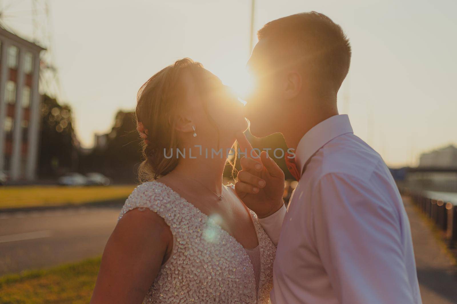 A kiss of the bride and groom at sunset. Wedding article. A happy couple. Love. Photos for printed products. Romance