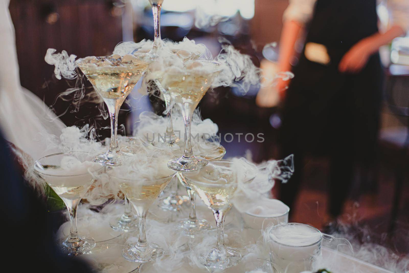 The bride and groom fill the champagne fountain. Wedding article. A happy couple. Love. Photos for printed products. Romance. Wedding catalog