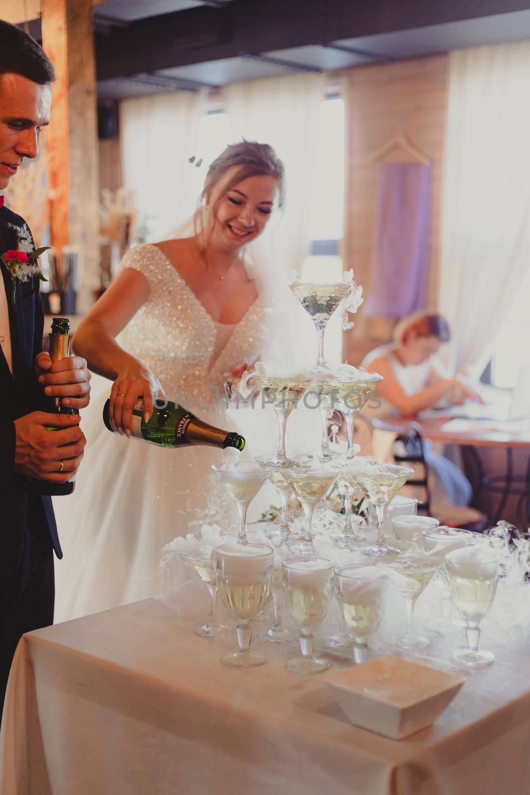 The bride and groom fill the champagne fountain. Wedding article. A happy couple. Love. Photos for printed products. Romance. Wedding catalog