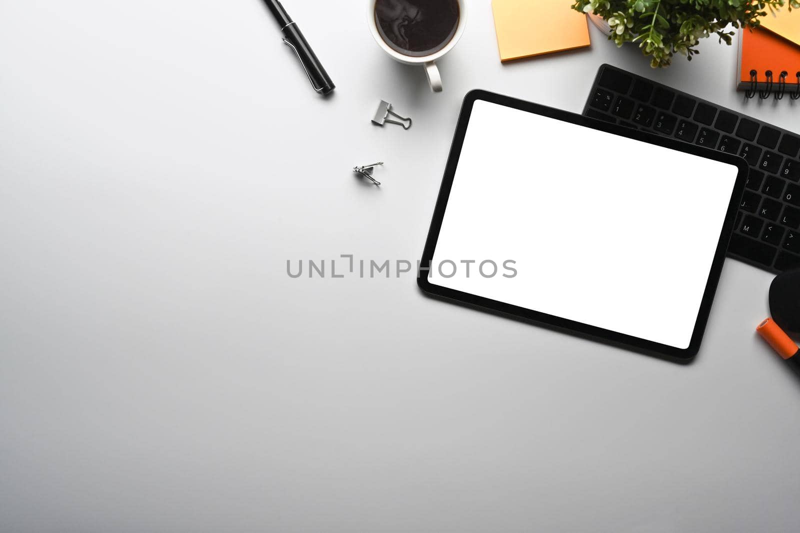 Top view creative workspace with digital tablet, coffee cup and supplies. by prathanchorruangsak