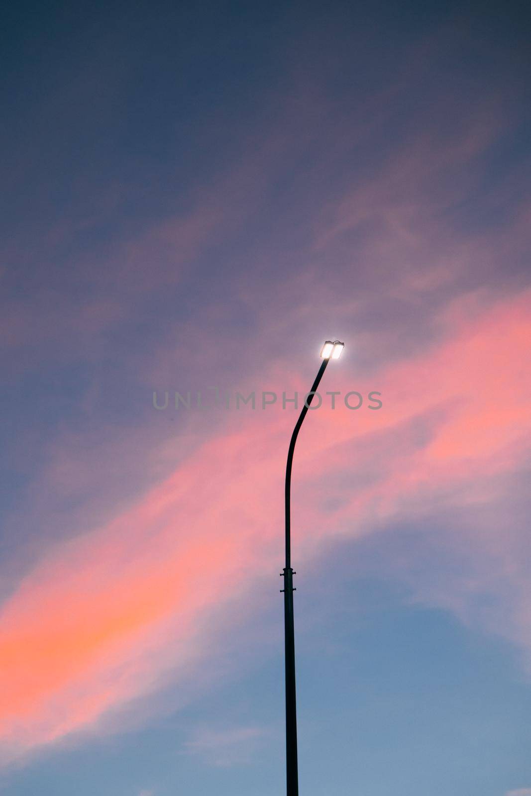 Lamppost at sunset . Sunset time. Copy space. An article about electricity. by alenka2194