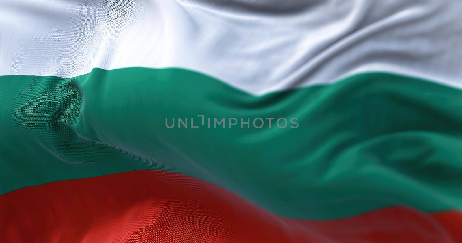 Close-up view of the Bulgaria national flag waving in the wind. Bulgaria is a country in Southeast Europe. Fabric textured background. Selective focus
