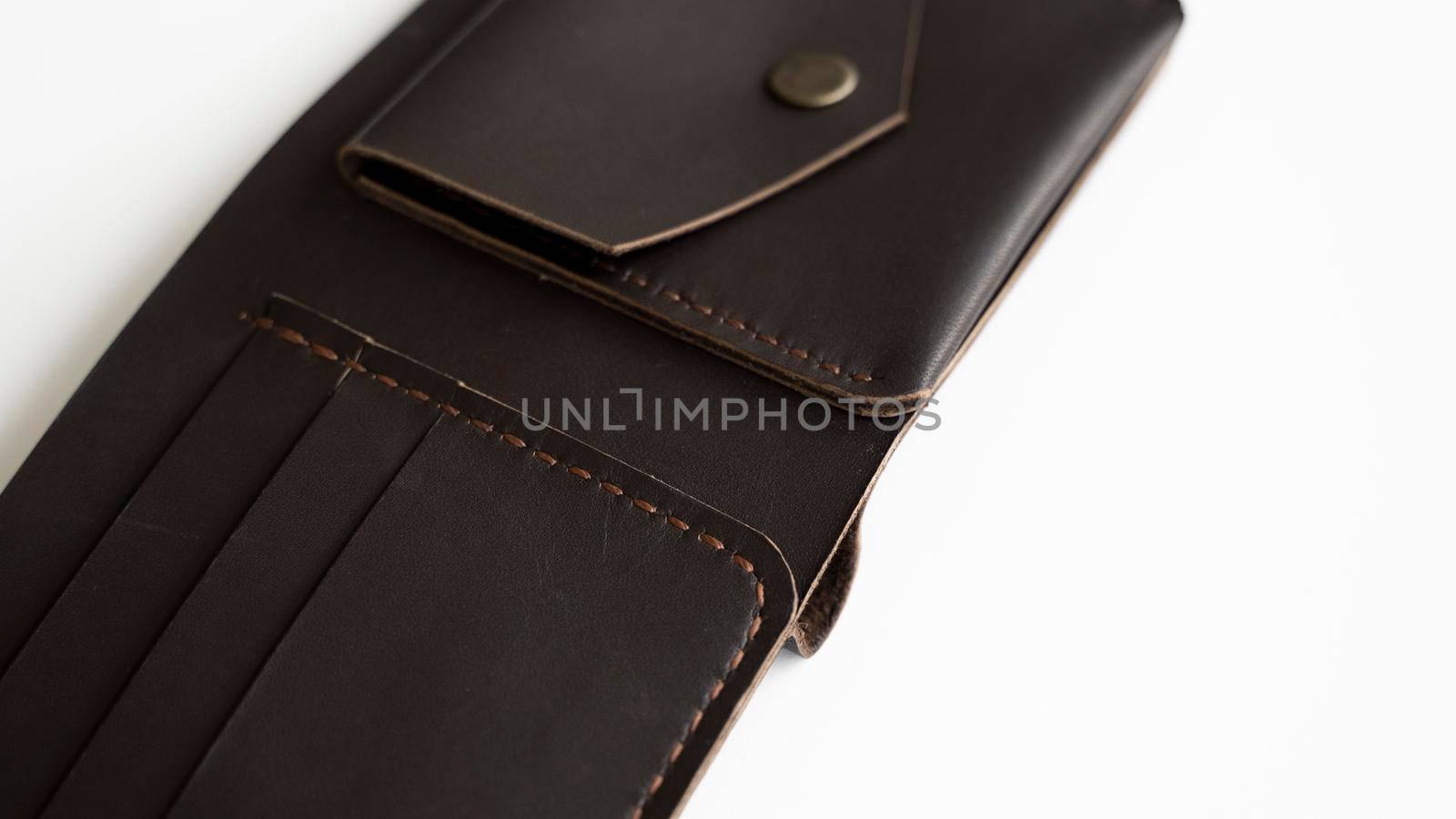 Man's open handmade dark brown genuine leather wallets on a white background. Leather goods and accessory