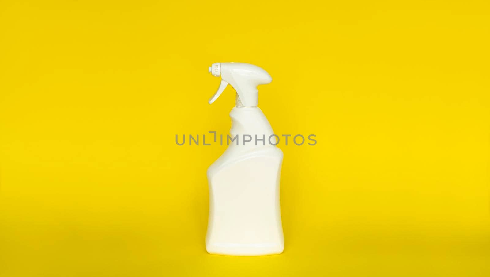 White blank plastic spray detergent isolated on yellow background. Packaging template mockup