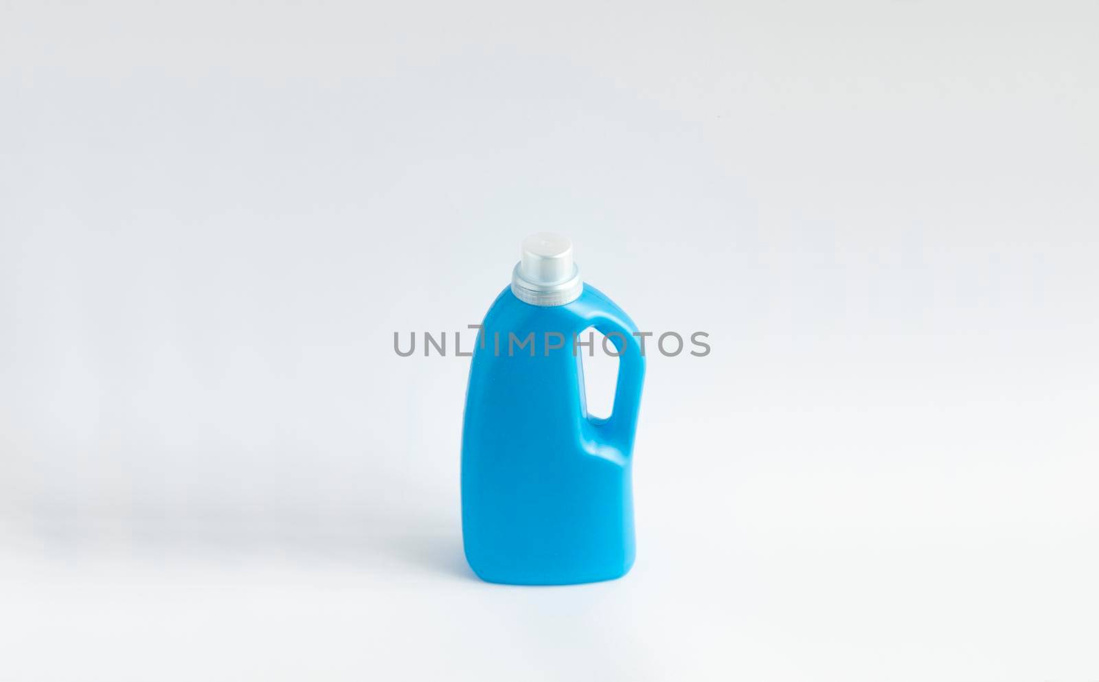 Blue plastic bottle with a grey cap isolated on white background for liquid detergent laundry or cleaning agent. Packaging template mockup. by vovsht