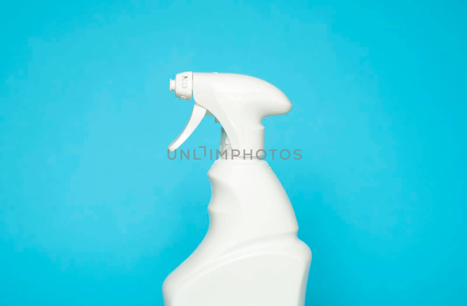 White blank plastic spray detergent bottle isolated on blue background. Packaging template mockup. by vovsht