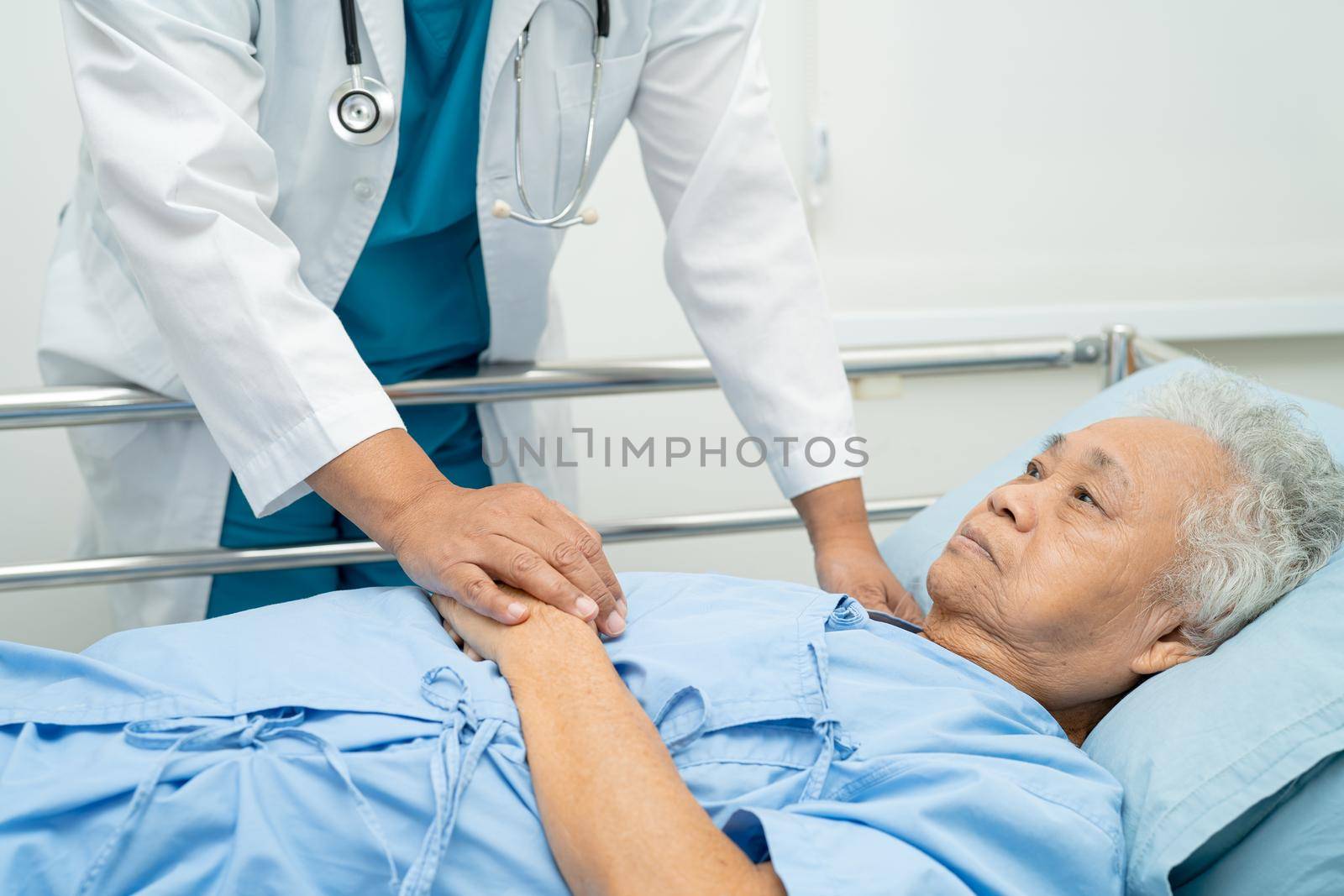 Holding hands Asian senior or elderly old lady woman patient with love, care, encourage and empathy at nursing hospital ward, healthy strong medical concept