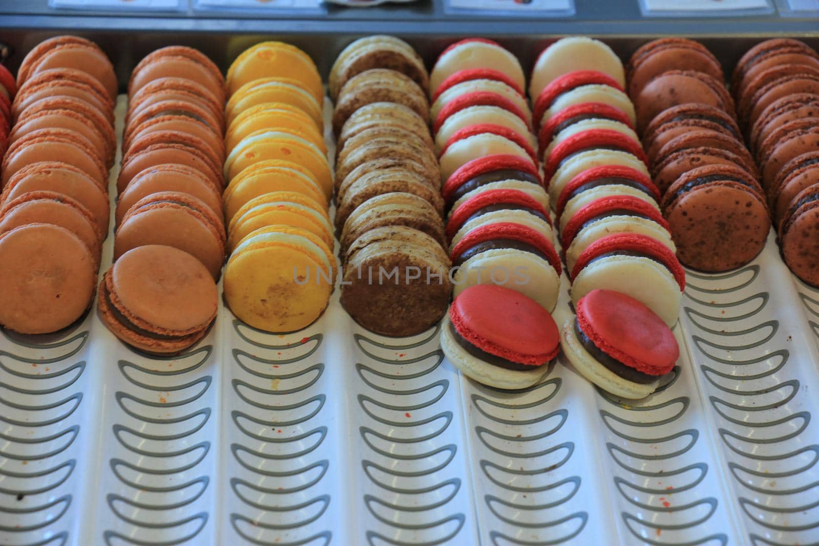 Macarons in various flavors and colors on display in a store