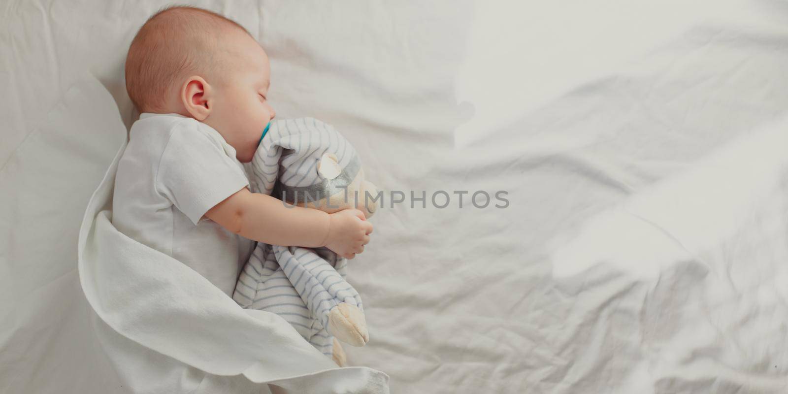 The baby is sleeping in his crib. Happy baby dream. A happy child. Children's article. by alenka2194