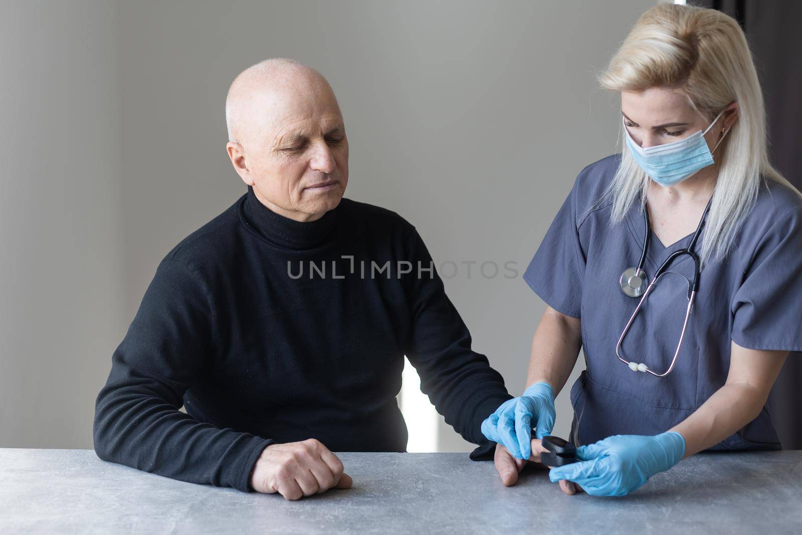 elderly man and nurse measuring pulse oximeter.