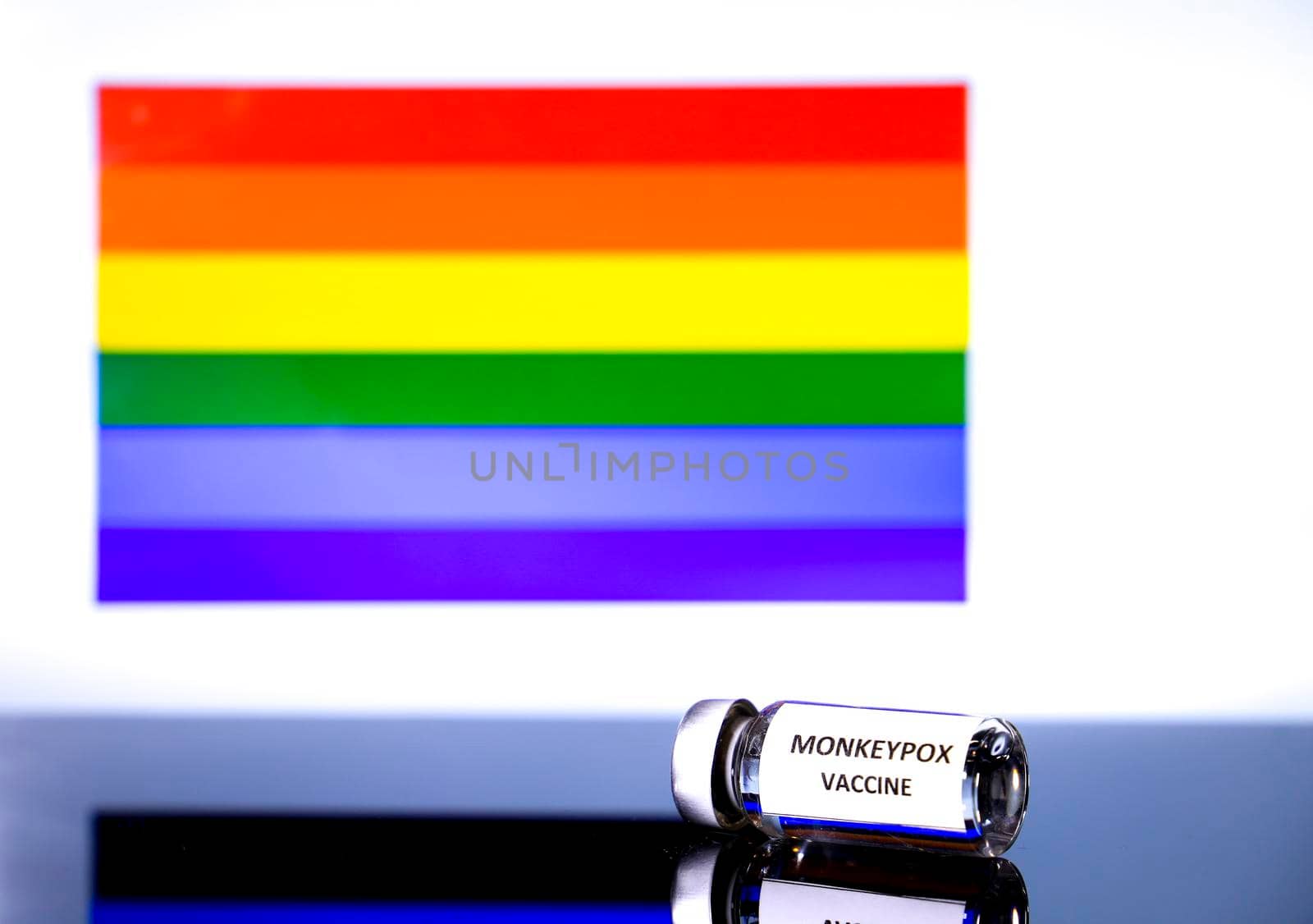 Vial with monkeypox vaccine and rainbow flag by soniabonet
