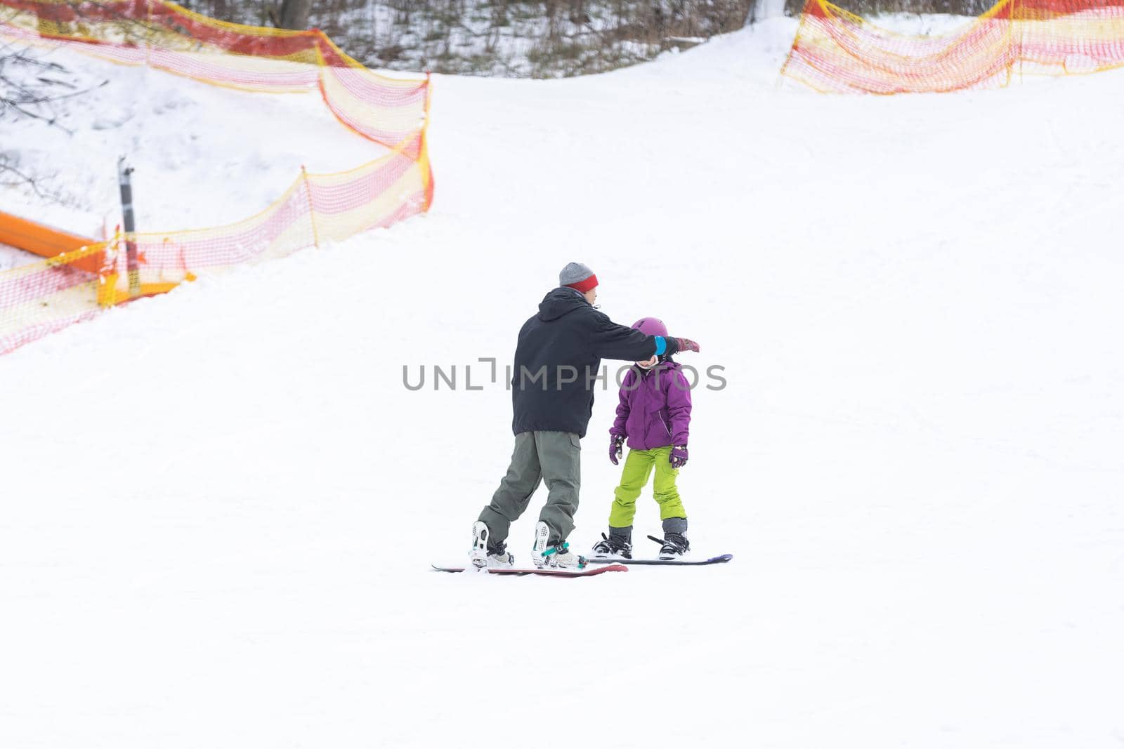 Ski Resort Father Teaching Little Daughter Snowboarding by Andelov13