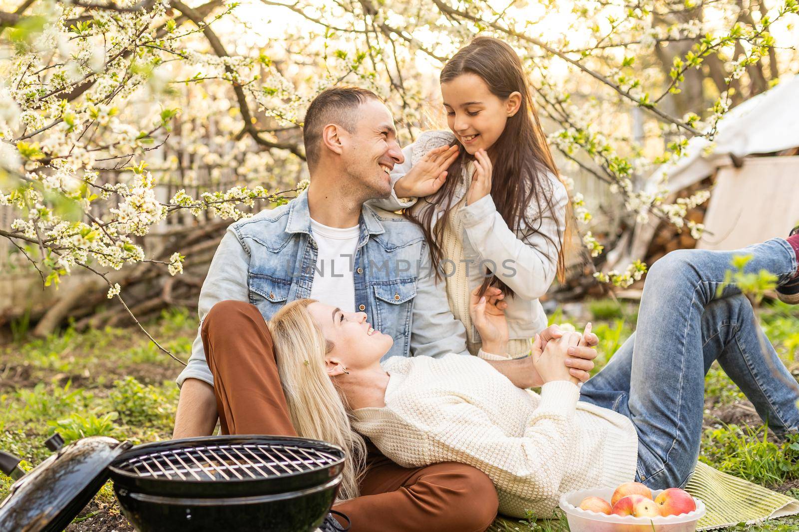 Happy family having barbecue with modern grill outdoors.