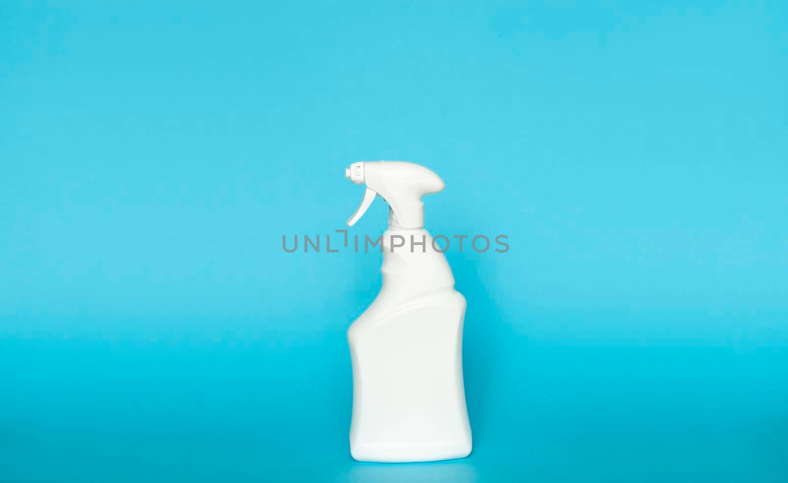 White blank plastic spray detergent bottle isolated on blue background. Packaging template mockup