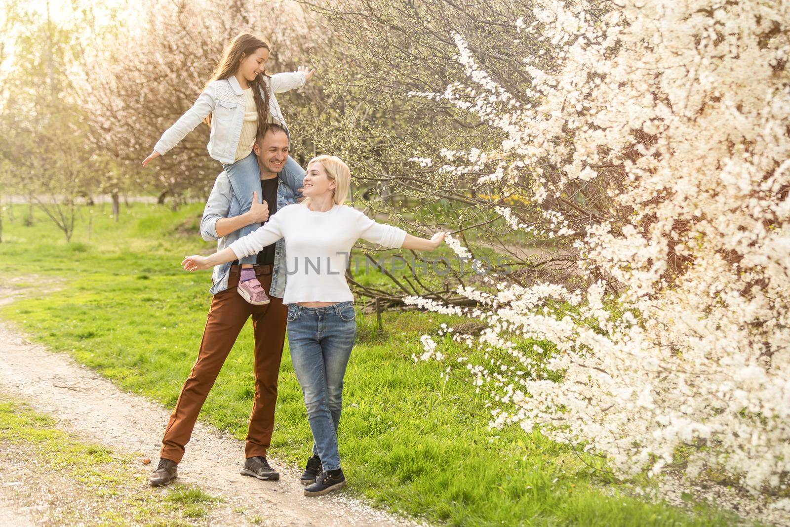 family in a blooming spring garden. Concept of happy family.