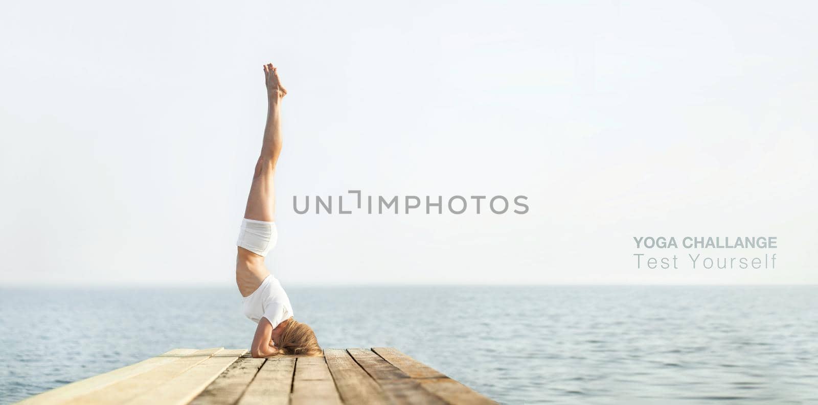 Beautiful blond woman practicing yoga at seashore and meditating