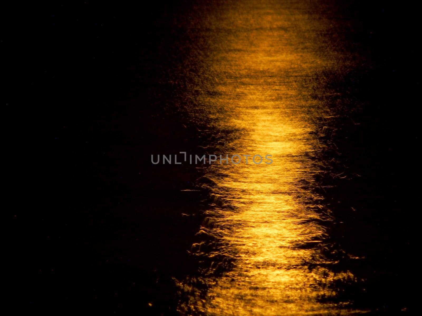 Orange Moon Light Reflects on the ocean.