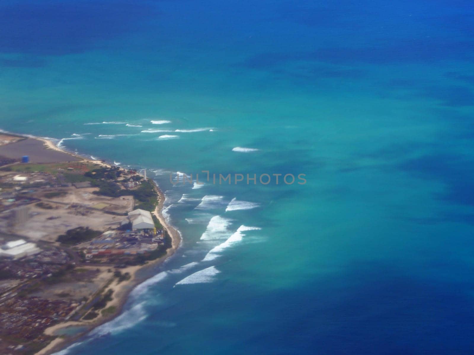 Aerial of Waves rolling towards Barbers Point on Oahu by EricGBVD